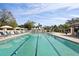 A pristine community pool with lounge chairs and a covered seating area at 4857 Tobermory Way, Bradenton, FL 34211