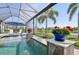 Stunning swimming pool with decorative waterfalls, lush greenery, and a clear view of the surrounding landscape at 4857 Tobermory Way, Bradenton, FL 34211