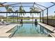 Sparkling pool with screened enclosure and waterfront views, perfect for relaxation and enjoying the scenery at 4857 Tobermory Way, Bradenton, FL 34211