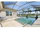 Beautiful pool area with screened enclosure, waterfront view, and lounge chairs at 4857 Tobermory Way, Bradenton, FL 34211
