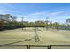 Well-maintained tennis courts with lighting and lush landscaping, providing an active recreational space at 4857 Tobermory Way, Bradenton, FL 34211