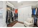 Spacious walk-in closet with custom white cabinets and shelving for optimal organization at 4857 Tobermory Way, Bradenton, FL 34211