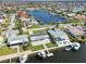 Aerial view of a light blue waterfront house and surrounding neighborhood, showcasing canal access at 5321 Bowline Bnd, New Port Richey, FL 34652