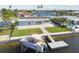 Aerial view of the home and dock with a boat lift, showcasing waterfront living at 5321 Bowline Bnd, New Port Richey, FL 34652
