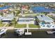 Aerial view of a waterfront property with a private dock, boat lift, and a pool, showcasing its prime location at 5321 Bowline Bnd, New Port Richey, FL 34652