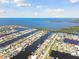 Stunning aerial view of waterfront homes, showcasing canal access to the open bay and ocean beyond at 5321 Bowline Bnd, New Port Richey, FL 34652