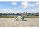 Backyard patio with blue and white chairs overlooks the canal and boat docks at 5321 Bowline Bnd, New Port Richey, FL 34652