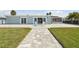 Charming exterior boasts a lush backyard, spacious patio, and serene outdoor setting at 5321 Bowline Bnd, New Port Richey, FL 34652
