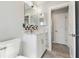 Stylish bathroom with a white vanity, decorative backsplash, and tile flooring at 5321 Bowline Bnd, New Port Richey, FL 34652