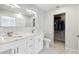 Well-lit bathroom with double sinks, elegant mirrors, and modern tile accents at 5321 Bowline Bnd, New Port Richey, FL 34652