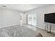This bedroom features ceramic tile flooring and access to a patio at 5321 Bowline Bnd, New Port Richey, FL 34652