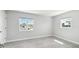 Bright bedroom with tile floor, two windows, and a neutral color scheme at 5321 Bowline Bnd, New Port Richey, FL 34652