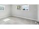 Minimalist bedroom featuring tile flooring, neutral walls, and two windows at 5321 Bowline Bnd, New Port Richey, FL 34652