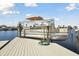 Boat lift holding a boat on a sunny day, ready for waterfront adventures at 5321 Bowline Bnd, New Port Richey, FL 34652