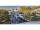 View of the beach club's gated entrance with mature trees and glimpse of the beach at 5321 Bowline Bnd, New Port Richey, FL 34652