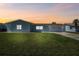 Charming single-story home featuring a well-manicured lawn and an attached two-car garage during a colorful sunset at 5321 Bowline Bnd, New Port Richey, FL 34652