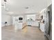 Bright kitchen with white cabinets, stainless steel appliances, a large island, and an open floor plan at 5321 Bowline Bnd, New Port Richey, FL 34652
