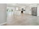 Bright, open kitchen featuring a large island, stainless steel appliances, and access to the waterfront patio at 5321 Bowline Bnd, New Port Richey, FL 34652
