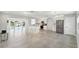 Bright, open kitchen featuring a large island, stainless steel appliances, and access to the waterfront patio at 5321 Bowline Bnd, New Port Richey, FL 34652