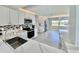 Modern kitchen with stainless steel appliances, white cabinetry, and stylish backsplash at 5321 Bowline Bnd, New Port Richey, FL 34652