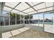 Enclosed lanai featuring views of the water and a paver patio at 5321 Bowline Bnd, New Port Richey, FL 34652