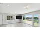 Living room with water view, sliding doors, and modern lighting at 5321 Bowline Bnd, New Port Richey, FL 34652