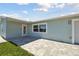 Paved patio area with access to the house and garage, perfect for outdoor entertaining at 5321 Bowline Bnd, New Port Richey, FL 34652