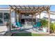 Outdoor seating area with rocking chairs under a wooden pergola, perfect for relaxation in this backyard at 553 E Lake Dr, Largo, FL 33771