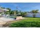 Expansive backyard featuring a sparkling swimming pool and a covered patio area for outdoor enjoyment at 553 E Lake Dr, Largo, FL 33771