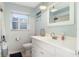 Well-lit bathroom with a white vanity, toilet, and shower featuring a clean and fresh aesthetic for daily comfort at 553 E Lake Dr, Largo, FL 33771