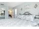 Bright bedroom with a patterned bedspread and wrought iron headboard in a stylish home at 553 E Lake Dr, Largo, FL 33771