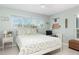 Cozy bedroom featuring a bed, a desk with rolling chair, a window, and decorations for a comfortable space at 553 E Lake Dr, Largo, FL 33771