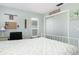Calm bedroom featuring a bed, a desk with rolling chair, a window, and sliding door closet at 553 E Lake Dr, Largo, FL 33771