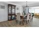 Charming dining room with seating for six and dark wood china cabinet for display storage at 553 E Lake Dr, Largo, FL 33771