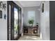 Inviting foyer with a wood console table, dark wood door with glass panels, and neutral decor at 553 E Lake Dr, Largo, FL 33771