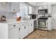 Clean and organized kitchen featuring stainless steel appliances and white cabinetry at 553 E Lake Dr, Largo, FL 33771