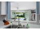 Kitchen view through passthrough window to outdoor pool area and indoor bar at 553 E Lake Dr, Largo, FL 33771