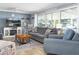 Cozy living room with a large TV above a fireplace, comfortable seating, and natural light at 553 E Lake Dr, Largo, FL 33771