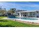 A refreshing swimming pool surrounded by a patio, a shed, and an awning, for a relaxing backyard at 553 E Lake Dr, Largo, FL 33771