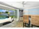 Indoor poolside bar with a view of a pool waterfall feature, bar seating, and a television at 553 E Lake Dr, Largo, FL 33771