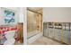 Bathroom featuring a bathtub, shower, toilet, and fixtures. There is a window for natural light at 5815 Bali S Way, St Pete Beach, FL 33706