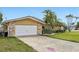 Beautiful home with a wide driveway, manicured lawn, and stone detailing on the exterior at 5815 Bali S Way, St Pete Beach, FL 33706