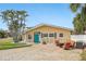 Charming single-story home with a well-manicured lawn and outdoor seating at 5815 Bali S Way, St Pete Beach, FL 33706