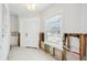 Hallway featuring white walls, door, window, and tile flooring during renovation at 5815 Bali S Way, St Pete Beach, FL 33706