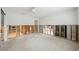 Open-concept living room with exposed studs, ceiling fan, and lots of room for personalization at 5815 Bali S Way, St Pete Beach, FL 33706