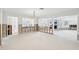 Renovated open living room with exposed walls and view of adjacent rooms, lit by natural light at 5815 Bali S Way, St Pete Beach, FL 33706