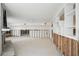 Spacious living room with a fireplace, white walls, and ample natural light at 5815 Bali S Way, St Pete Beach, FL 33706
