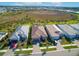 Aerial view of several homes with well-maintained landscaping and tile roofs in a neighborhood near a pond at 6104 Talon Preserve Dr, Nokomis, FL 34275