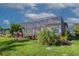 Lush backyard featuring tropical landscaping and a screened lanai, offering a serene and private outdoor space at 6104 Talon Preserve Dr, Nokomis, FL 34275