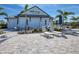 Exterior view of Hideaway Bar & Grille with outdoor seating and a modern design at 6104 Talon Preserve Dr, Nokomis, FL 34275